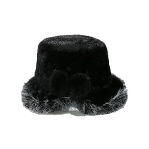 Detailed macro of black faux fur bucket hat with bow accent and gray trim edge