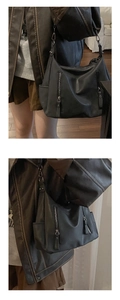Close-up of black soft leather tote bag featuring silver zipper and biker style details