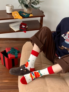 Detail of Christmas cotton crew socks with festive Santa and gingerbread man patterns