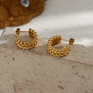Detailed view of 18K gold plated hoop earrings with wheat grain texture on stone