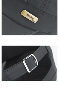 Detailed macro of metal brand logo and adjustable buckle on dark grey sun hat