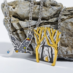 Vintage stainless steel necklaces featuring colorful flying bird and forest tree pendants