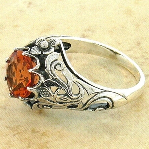 Vintage silver hollow ring with large oval orange gemstone and floral texture