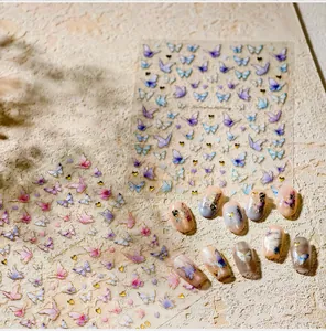 Detailed view of 3D butterfly nail stickers with gold outlines and iridescent gradients