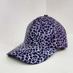 Detailed view of the purple leopard print pattern on a faux leather baseball cap texture