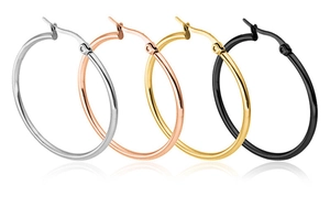 Close-up of oversized hoop earrings in silver, rose gold, gold, and black stainless steel