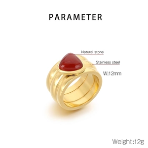 Detail of 12mm wide gold plated stainless steel ring with red natural stone inlay