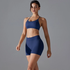 Detail view of seamless dark blue yoga set with spaghetti strap bra and high waist shorts