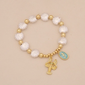 Detailed shot of ocean-themed beaded bracelet with gold lobster and blue seahorse charms