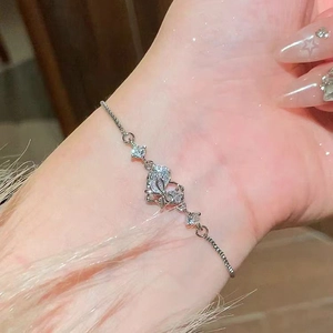 Detail of silver heart butterfly bracelet with sparkling zircon stones on female wrist