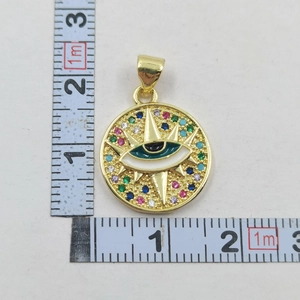 Close-up of gold Evil Eye pendant with colorful stones and ruler showing 2.3cm height