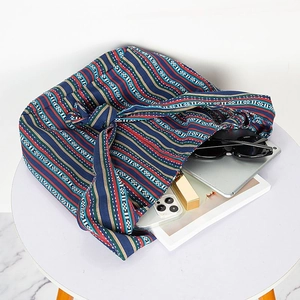 Spacious ethnic canvas bag with navy stripes showing interior storage for tablet and essentials