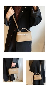 Close-up of beige lychee leather handbag showing dual zippers and detachable strap