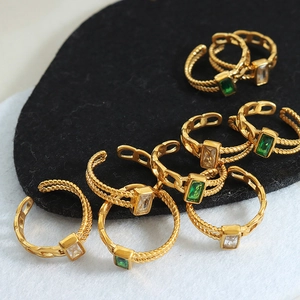 Minimalist gold titanium steel ring with emerald zircon stones and woven chain texture