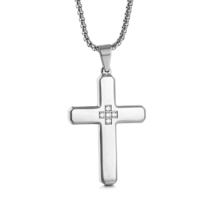 Macro shot of silver stainless steel cross pendant with diamond-set small cross pattern