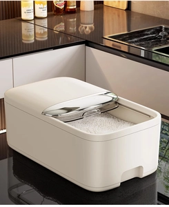 Close-up of airtight cream-white rice container with metal-finish lid in a modern kitchen