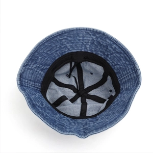 Internal view of the denim bucket hat showing black sweatband and reinforced stitching