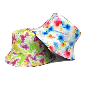Close-up of vibrant tie-dye bucket hats with detailed watercolor texture and sturdy canvas fabric