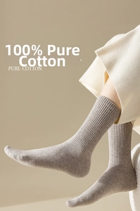 Close-up of khaki crew socks in 100% pure cotton rib knit texture worn by model