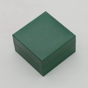 Dark green faux leather watch box with a classic lychee texture and flip cover design