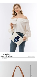 Detailansicht der Canvas-Clutch mit Hamsa-Hand-Stickerei und braunem Lederarmband