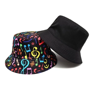 Reversible bucket hat with musical notes print and plain black side for outdoor sun protection