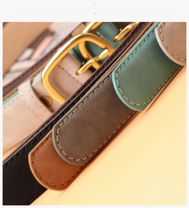 Detail of suede belts with vintage gold buckles and fine stitching in multiple colors