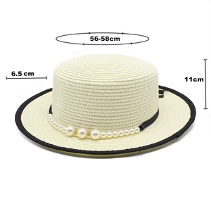 Detail of boater hat with black binding, faux pearl trim, and size measurements