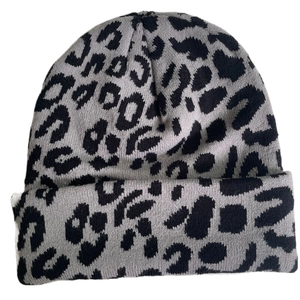 Detailed close-up of grey and black leopard print pattern on knitted beanie hat