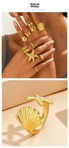 Detailed close-up of golden ocean-themed rings featuring starfish and shell designs