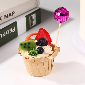 Sparkling purple disco ball cake topper on a fruit cupcake for festive party decorations