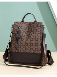 Detail of vintage monogram print on dark brown leather backpack for women with high texture