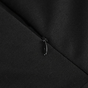 Detailed close-up of a concealed zipper on a black evening gown fabric with fine texture