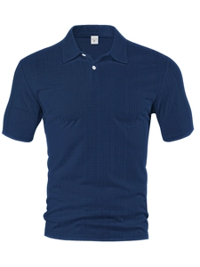 Detailed view of navy blue waffle texture fabric and collar on a men's short sleeve shirt