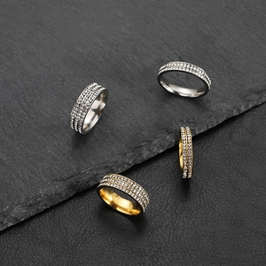 Macro detail of 2mm minimalist stainless steel rings with sparkling micro-pave stones