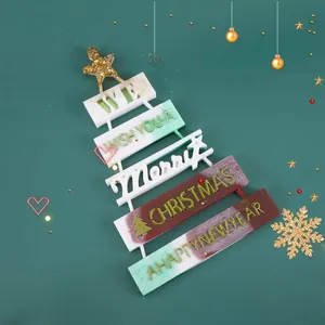Close-up of a layered Christmas tree hanging ornament with Merry Christmas typography