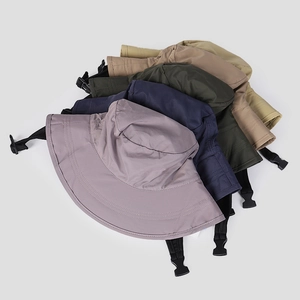 Macro view showing multiple colors of nylon quick-dry bucket hats with chin straps