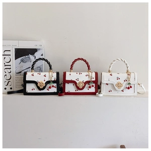 Three mini crossbody bags with cherry prints, twist handles, and floral metal buckles