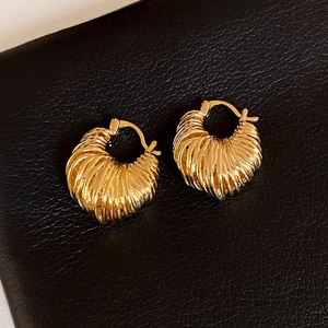 Elegant gold chunky ribbed hoop earrings featuring a stylish vintage croissant texture
