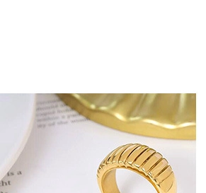 Detailed macro view of a gold-plated croissant ring with a vintage textured finish