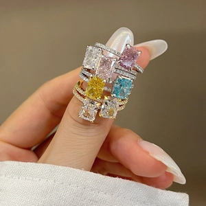 Hand wearing seven stackable S925 silver rings with colorful 8A ice-cut zircon stones