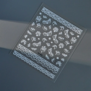 Macro view of 5D white lace nail stickers with floral and bow patterns, style Co-437