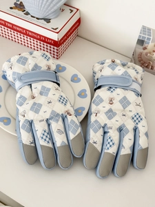 Detail of waterproof ski gloves featuring non-slip fingertips and teddy bear pattern