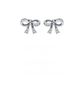Macro detail of silver bow stud earrings with sparkling pavé cubic zirconia inlay