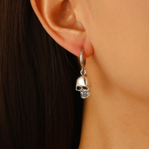Retro punk rock skull hoop earring in vintage silver finish worn by model on ear