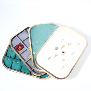 Detailed view of metal jewelry trays with dark green and grey microfiber compartments