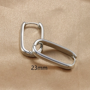 Macro shot of silver U-shaped earrings showing the 23mm size detail and hinge mechanism