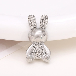 Macro shot of silver bunny metal charm with sparkling rhinestones for shoe accessories