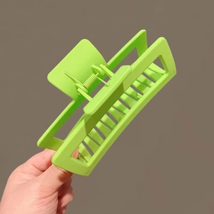 Close-up of a 13cm matte neon green large square hair claw clip with a strong metal spring