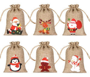 Detailed view of six Christmas burlap drawstring gift bags with various holiday character prints
